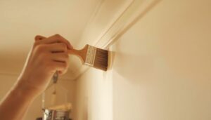 Cutting in paint technique using a angled brush along ceiling edges and corners